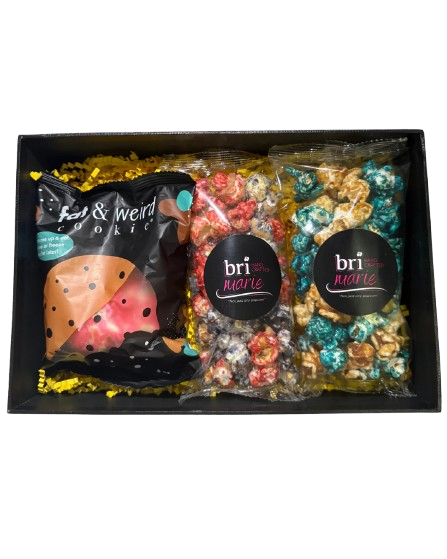 Bri Marie Popcorn gift box with assorted gourmet popcorn bags and a Fat & Weird Cookie arranged in a black tray.