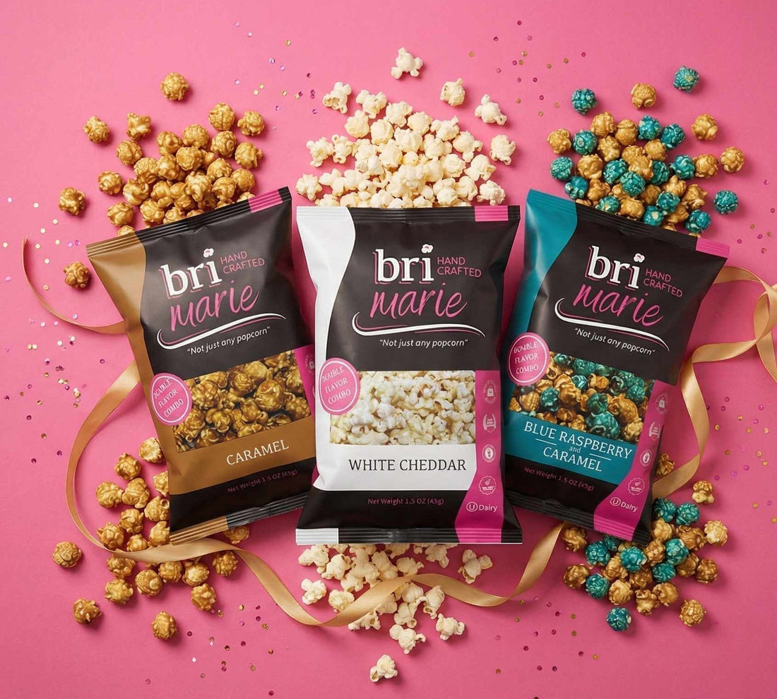 Bri Marie gourmet popcorn in caramel, white cheddar, and blue raspberry caramel flavors displayed on a pink background
