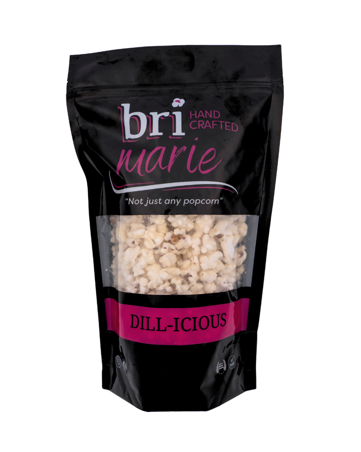Bri Marie Dill-icious popcorn with tangy dill flavor in a bowl, featuring non-GMO popcorn kernels.