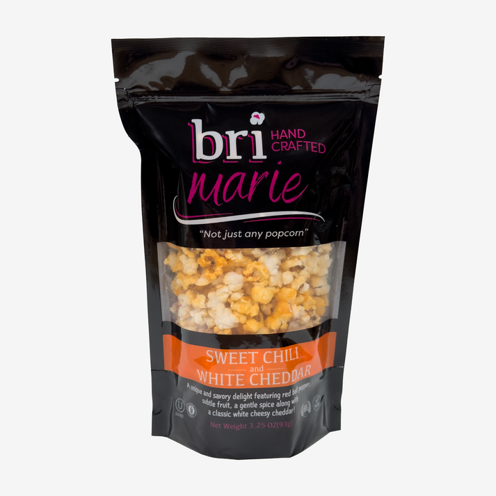 Bri Marie Blue Raspberry & Caramel popcorn with tangy dill flavor in a bowl, featuring non-GMO popcorn kernels.