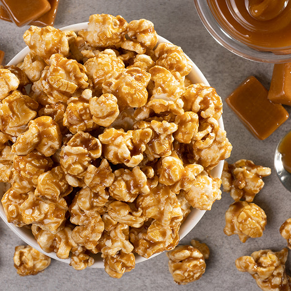 Golden caramel-coated gourmet popcorn kernels.